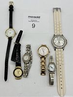 Full view of six ladies wristwatches with various straps and faces, showing overall lot contents