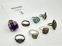 All 8 sterling silver rings displayed together, showing variety of stones and designs