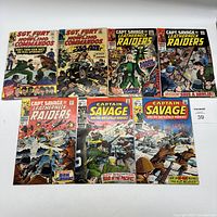 Front view of eight vintage Marvel comic books laid out side by side. Titles visible: Sgt Fury and His Howling Commandos, Captain Savage and His Leatherneck Raiders, Captain Savage and His Battlefield Raiders.