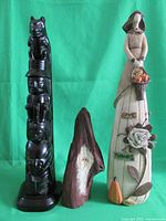 Full view of the three collectible pieces including the black totem carving, driftwood folk fairy art, and fall harvest art with 'Give Thanks' base
