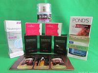 Photo of the full lot showing all beauty products including serums, creams, refills, and sample sachets