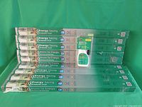 Photo showing 10 boxes of Gila Energy Saving Window Film stacked, with an application kit in front.