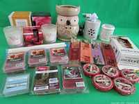 Overview of assorted wax melt refills, soy candle in box, and electric wax warmers.