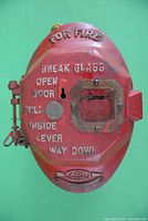 Front view of the red ADT vintage fire alarm box showing embossed instructions and ADT logo.