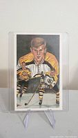 Front view of Bobby Orr hockey card showing illustrated portrait and action hockey images.