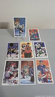 Photo of 9 hockey portrait cards arranged on table with various players in action