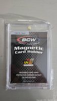 Front view of brand new sealed BCW magnetic card holder packaging showing product details like '130 Pc. Card' capacity and UV protection.