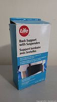 Boxed Life Brand back support product showing front and side with dual strap feature.