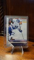 Front photo of Nick Robertson YoungGuns rookie retro hockey card showing player in Toronto Maple Leafs uniform in action pose.