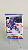Front side of Rod Brind'Amour rookie card featuring action shot in Blues uniform.
