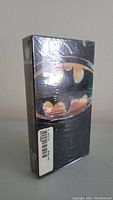 Front view of vintage unopened Batman VHS tape in shrink wrap showing Batman logo