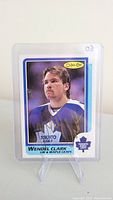 Front photo of the Wendel Clark autographed rookie card showing the player's portrait, autograph in gold ink, O-Pee-Chee branding and Toronto Maple Leafs logo.