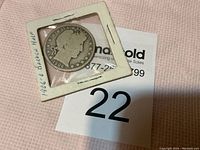 1906-O Barber Half Dollar coin front side visible in protective white cardboard holder with label indicating '1906 O Barber Half'.