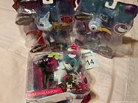 Photo showing three Bratzillaz figures in original packaging, including Kumi with green pet, James with gray pet, and Barkthalamow with two pets.