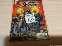 Front cover of Ghost Rider comic book with visible signature and MaxSold lot tag.