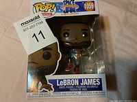 Front view of the LeBron James Pop! vinyl figure in box showing branding and figure details.
