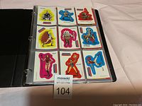 Single plastic page with nine Masters of the Universe character cards including Skeletor, Teela, Man-At-Arms, and others