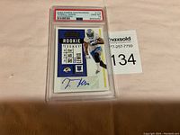 Two photographs showing two signed Terrell Lewis rookie cards graded Gem Mint 10 by PSA, each in a plastic protective case with authentication label.