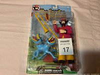 Front view of unopened The Beatles Yellow Submarine figurine in original blister packaging showing the male character, the blue two-headed dog, and yellow trombone accessory.