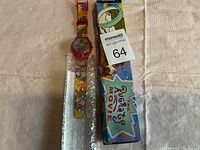 Wristwatch with colorful Rugrats Movie illustrations on the band, resting on a surface next to its original box featuring character artwork.