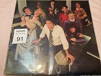 Close-up photo of the album cover showing the detail of the artwork and the worn condition of the sleeve