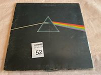 Front of The Dark Side of the Moon album cover showing prism design with visible wear and writing marks