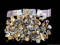 Photo showing a large assortment of mismatched costume jewelry parts in various designs, colors, and metals.