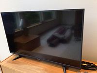 42 inch Toshiba flat screen TV on wooden stand.