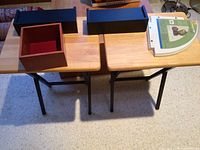 Photo from above showing two TV trays and four wall shelves on them