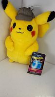 Yellow Detective Pikachu plush with detective hat and original tags in a box.