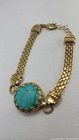Front view of bracelet showing turquoise stone and chain detail.