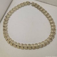 Full view of vintage silver tone choker necklace showing overall design and clasp.