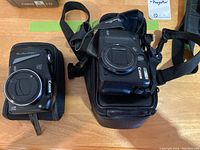 Overview of both Canon cameras and their cases on a table