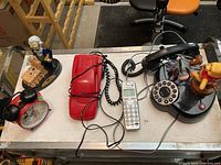 Image showing all items from above with visible Mickey Mouse red alarm clock, battery toy figurine, red rotary phone, white cordless phone and Winnie the Pooh rotary-like phone.