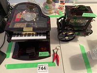 Both Kings piano and Etranger organ music boxes together with small additional keychain items.