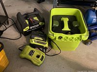 Ryobi 1600 PSI electric pressure washer unit, two battery chargers, and the top unit of a Sun Joe pressure washer in green and black.