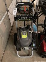 Front view of Ryobi pressure washer showing engine cover, branding, and main frame.