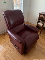 Right-side front three-quarter view showing vinyl upholstery, padded cushions and manual lever.