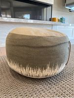 Footstool pouf showing overall round shape and fabric pattern