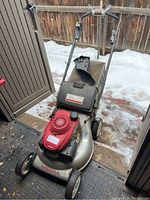 Full three-quarter view of Honda self-propelled mower showing engine, deck and wheels