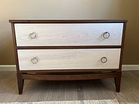 Front view of nightstand showing two-tone drawer fronts with stainless steel ring pulls