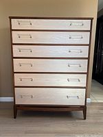 Front view of six-drawer walnut dresser with two-tone stain and lucite handles