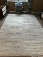 Full view of the Threshold floor rug spread out on the floor with furniture on the sides.