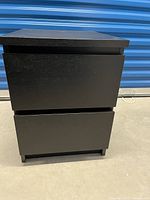 Front view of one black MALM 2-drawer chest with drawer partially open.
