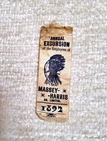 Front of fabric ribbon showing text and Native American chief graphic, marked 1892 Massey Harris Co.