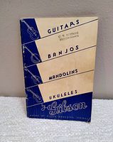 Front cover of 1930s Gibson booklet showing instruments listed: guitars, banjos, mandolins, ukuleles by Gibson.