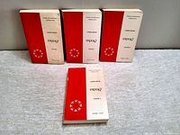 Four General Report books for Expo 67 with three standing upright and one lying flat, showing the Expo 67 logo and volume numbers on covers. Volume I cover shows noticeable soiling.