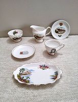 Full lot display showing all five pieces with detailed cottage and floral design on bone china