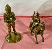 Two solid brass knight figurines; one standing and one mounted on a horse. Both show detailed armor and aged brass patina.