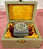Stone block with carved dragon top inside gold satin-lined display box
